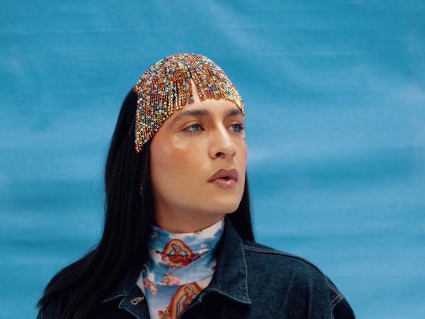 A portrait of a non-binary Latinx person - big, bold and beautiful