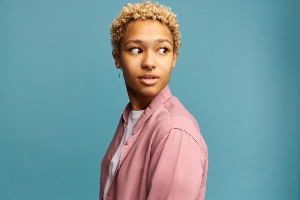 black girl with blond curls turning head to scary sound looking aside