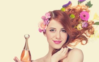 woman holding perfume with bright colors surrounding her