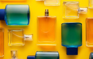 Perfume bottles organized over yellow background