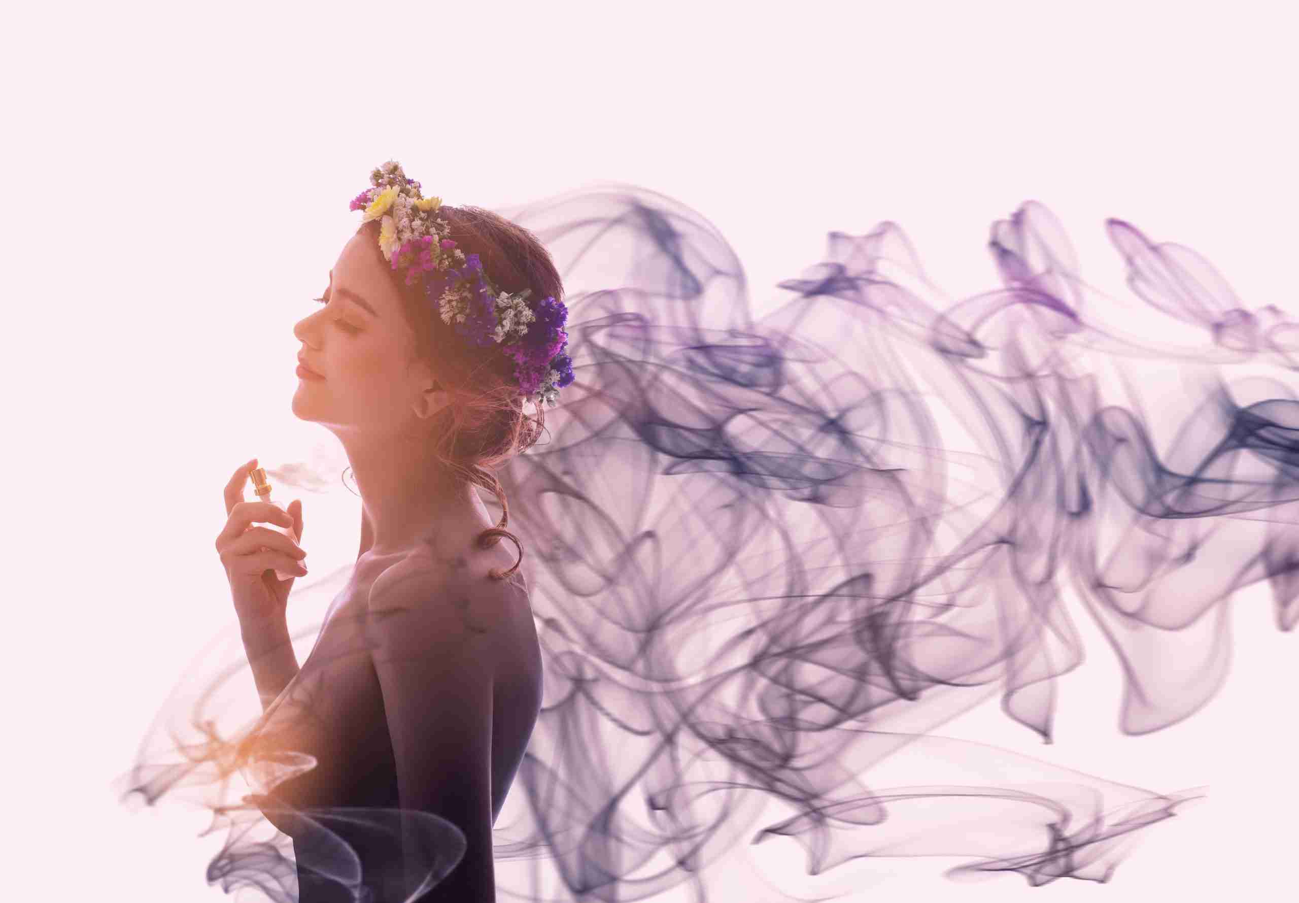 Charming woman spray perfume on her body. She has sexual attract