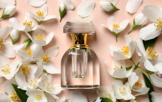 Bottle of luxury perfume and fresh jasmine flowers