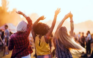 Multiethnic friends celebrating summer music festival