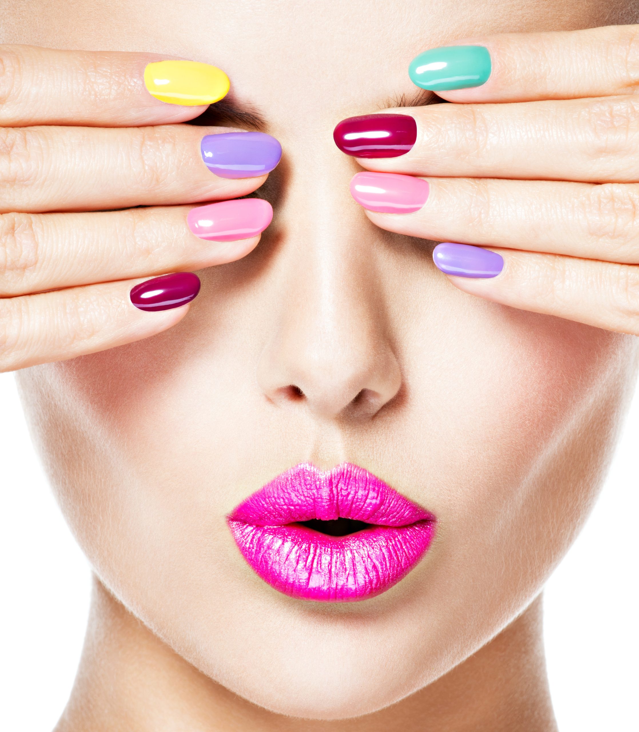 Close-up face of a woman with multicolor nails pink lips